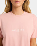 Billabong Womens Pacific Tee in Pale Peach close up view highlighting the premium 180gsm cotton jersey fabric texture soft garment-washed finish ribbed crew neckband quality stitching and distinctive Billabong chest print detailing, sold by Point Break Cambridge local family surf shop at 63 Duke Street.