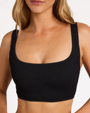 Billabong Womens Summer Hi Crop Bikini Top in Black Sands charcoal black close up view highlighting the premium soft ribbed texture fabric weave pattern seamless edge lining and metal brand logo badge detail, sold by Point Break Cambridge local family surf shop at 63 Duke street.