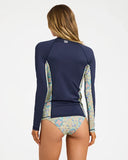 Billabong Womens Sunset Nomad Pipa Long Sleeve Sunshirt in Classic Navy back view highlighting the classic-fit rashguard silhouette navy stretch fabric printed side body panels long sleeve sun protection design and signature Billabong centre back branding, sold by Point Break Cambridge local family surf shop at 63 Duke Street.