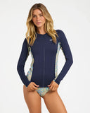 Billabong Womens Sunset Nomad Pipa Long Sleeve Sunshirt in Classic Navy front view showcasing the full-length zip closure classic navy body comfortable crew neckline long sleeves with printed lower panels and signature Billabong left chest branding, sold by Point Break Cambridge local family surf shop at 63 Duke Street.