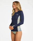Billabong Womens Sunset Nomad Pipa Long Sleeve Sunshirt in Classic Navy side profile view showcasing the streamlined classic fit flexible recycled polyester fabric printed lower sleeve and side body detailing with comfortable long sleeve coverage, sold by Point Break Cambridge local family surf shop at 63 Duke Street.