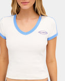 Billabong Womens Surf Vibe V Neck Tee in Salt Crystal close up view highlighting the premium 280gsm cotton jersey fabric texture contrast V neck binding quality stitching cap sleeve trim and signature Billabong screen printed chest graphic, sold by Point Break Cambridge local family surf shop at 63 Duke Street.