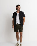 Man wearing a black shirt, white t-shirt, and green shorts on a white background Rhythm Mens Classic Chord Jam - Olive