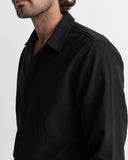 Man wearing a black shirt against a white background Rhythm Men's Classic Linen LS Shirt – Vintage Black