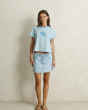 Model wearing the Rhythm Daisy Floral Stripe Tee - Baby Blue on a plain background