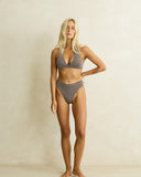 Model wearing the Rhythm Dreamer Halter Top - Chocolate on a plain background