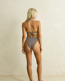 Model wearing the Rhythm Dreamer Halter Top - Chocolate on a plain background
