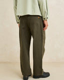 Model wearing the Rhythm Essential Relaxed Straight Jean - Olive on a plain background