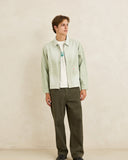 Model wearing the Rhythm Essential Relaxed Straight Jean - Olive on a plain background