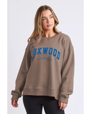 Woman wearing a brown sweatshirt with 'FOXWOOD' printed in blue on a white background