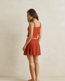 Model wearing the Rhythm Gigi Lace Mini Skirt - Red on a plain background