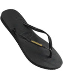 Havaianas Slim Logo Metallic Jandals in Black and Gold front view showing the elegant open toe thong configuration and delicate slim black straps with raised metallic gold logo print, sold by Point Break Cambridge local family surf shop at 63 Duke street.