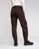 Brown pants worn by a person on a white background