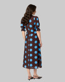 Leila + Luca Gathering Dress in Bold Blue Spot back view showing the elegant relaxed drape premium patterned fabric alignment and clean structural bodice paneled tailoring with flatlock seam stitching, sold by Point Break Cambridge local family surf shop at 63 Duke street.