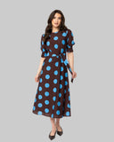 Leila + Luca Gathering Dress in Bold Blue Spot front view showing the elegant relaxed midi length silhouette flattering tailored neckline and clean casual flowing lower polka dot print hemline profile, sold by Point Break Cambridge local family surf shop at 63 Duke street.