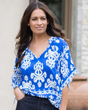 Front view of the Leila + Luca Model waring the Leila Luca Movement Blouse in Blue Wave, showing the relaxed contemporary drape and V neckline.