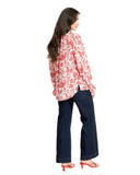 Leila + Luca New York Top in Ruby Pop colour long sleeve blouse side profile view showing the detailed sleeve construction, sold by Point Break Cambridge local family surf shop at 63 Duke street.