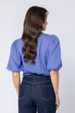 Back view of the ladies Leila + Luca Nina Blouse displaying the refined drape and clean baseline hem.