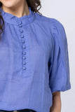 Close-up detail of the beautifully soft royal blue fabric and elegant collar stitching on the Leila and Luca blouse.
