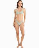 A model wearing a two-piece bikini with a light sage green and white gingham pattern, standing against a solid white background. Rhythm Lola Check Crop Bikini Top - Green