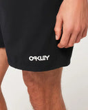 Oakley Beach Volley 16 inch Beachshort in Blackout matte black close up view highlighting the premium water resistant woven fabric texture branded drawcord tips and secure pocket drainage eyelet detail, sold by Point Break Cambridge local family surf shop at 63 Duke street.
