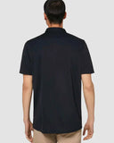Oakley Icon TN Protect Polo Shirt in Blackout back view showing the straight regular fit silhouette and rear embroidered neck detailing, sold by Point Break Cambridge local family surf shop at 63 Duke street.