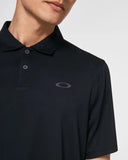 Oakley Icon TN Protect Polo Shirt in Blackout close up view highlighting the branded two button placket knit texture and Hydrolix moisture technology tags, sold by Point Break Cambridge local family surf shop at 63 Duke street.