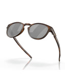 Oakley Latch Sunglasses in Matte Brown Tortoise front view showing the classic round lifestyle frame layout keyhole bridge structure and premium color-tuning Prizm Black lenses, sold by Point Break Cambridge local family surf shop at 63 Duke street.