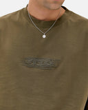 Oakley Mod Embroidered Tee in Deep Olive green close up view highlighting the premium soft performance knit fabric weave texture and detailed embroidered brand logo stitching finish, sold by Point Break Cambridge local family surf shop at 63 Duke street.