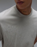 Oakley Rain Camo Tee in Cement grey close up view highlighting the premium soft performance knit fabric weave texture and detailed rain camo graphic finish print, sold by Point Break Cambridge local family surf shop at 63 Duke street.