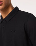 Oakley Relax Urban Polo Shirt in Blackout close up view highlighting the premium textured fabric weave, ribbed collar, and branded two button placket, sold by Point Break Cambridge local family surf shop at 63 Duke street.