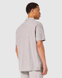 Oakley Relax Urban Polo Shirt in New Granite Heather grey back view showing the relaxed straight silhouette and premium shoulder stitching, sold by Point Break Cambridge local family surf shop at 63 Duke street.