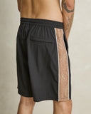 Model wearing the Rhythm Panel Stretch Beach Short - Black on a plain background