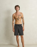 Model wearing the Rhythm Panel Stretch Beach Short - Black on a plain background