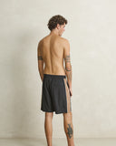 Model wearing the Rhythm Panel Stretch Beach Short - Black on a plain background