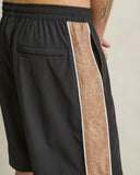 Model wearing the Rhythm Panel Stretch Beach Short - Black on a plain background