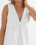 Model wearing the Rhythm Presley Dress - Off White on a plain background
