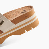 Close-up of a sandal with cork insole and visible brand logo on a white background