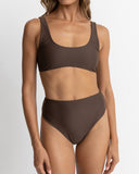 Rhythm Classic Crop Top in Chocolate brown close up view highlighting the premium lightweight fabric texture, high quality stitch detailing, and subtle woven brand tag, sold by Point Break Cambridge local family surf shop at 63 Duke street.