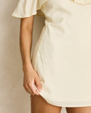 Rhythm Gigi Dress in Cream white close up view highlighting the premium lightweight fabric texture, high quality hem stitching, and subtle woven brand tag, sold by Point Break Cambridge local family surf shop at 63 Duke street.