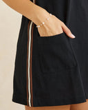Rhythm Hanalei Mini Dress in Black close up view highlighting the premium lightweight fabric texture, high-quality hem stitching, and subtle woven brand tag, sold by Point Break Cambridge local family surf shop at 63 Duke street.