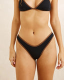 Rhythm Lily Rib Contrast Hi Cut Pant in Black bikini swimsuit bottoms close up view highlighting the premium textured rib fabric weave contrast trim detailing and subtle brand tag, sold by Point Break Cambridge local family surf shop at 63 Duke street.