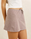 Rhythm London Check Bias Cut Mini Skirt in Chocolate brown side profile view highlighting the elegant hemline curvature and comfortable low profile side seam construction, sold by Point Break Cambridge local family surf shop at 63 Duke street.