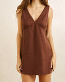 Rhythm Venice Mini Dress in Chocolate brown close up view highlighting the premium lightweight fabric texture, high quality hem stitching, and subtle woven brand tag, sold by Point Break Cambridge local family surf shop at 63 Duke street.