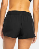Roxy Womens Wave 2 Inch Board Short in Anthracite back view highlighting the relaxed short-length silhouette, smooth recycled polyester stretch fabric, comfortable elasticated waistband and versatile charcoal-black coastal swimwear styling, sold by Point Break Cambridge local family surf shop at 63 Duke Street.
