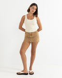 Model wearing the Rhythm Ruby Mini Skirt - Washed Sand on a white background