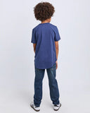 Person wearing a blue t-shirt and jeans on a white background. Back view of the Saint Goliath Boys STG Essential Tee in Navy showcasing the clean shoulders and straight jersey drape.