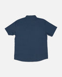 Salty Crew Mens Flagship UV Button Up in Mid Blue marine tone back view showing the clean relaxed shoulder yoke panel alignment and straight flexible lower split hemline drape, sold by Point Break Cambridge local family surf shop at 63 Duke street.