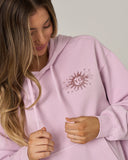 Salty Crew Womens Celestial Sun Hoodie in Pale Orchid pastel purple close up view highlighting the premium soft cotton weave vintage washed fleece texture kangaroo pocket borders and stitched brand clamp label, sold by Point Break Cambridge local family surf shop at 63 Duke street.