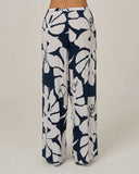 Salty Crew Womens Graphic Bloom Pant in Dark Navy blue back view highlighting the clean relaxed drape comfortable pocket alignment and straight casual lower ankle hemline architecture, sold by Point Break Cambridge local family surf shop at 63 Duke street.